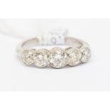 A diamond and platinum five stone ring, comprising five graduated round brilliant cut diamonds,