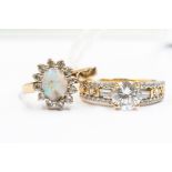 A 9ct gold and opal dress ring, claw set with a paste set surround, a/f opal very chipped, size T,