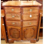 A George III and later serpentine fronted commode, the upper half with two doors with faux drawer