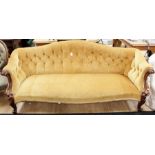 A Victorian walnut framed settee, deep buttoned back, sprung upholstered seat, raised on carved