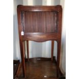 Three George III mahogany night commodes, late 18th Century, one with a tambour door, raised on