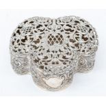 An Edwardian silver trefoil shaped pot pourri box, the body profusely chased with flowers,