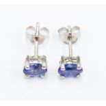 A pair of tanzanite and silver studs, comprising oval cut tanzanite approx.5 x 3mm, claw settings