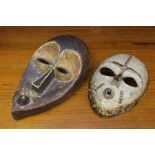 A group of four Edward Campden stoneware wall masks, 2000-2002, inspired by African tribal masks and