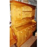 Modern pine dresser with plate rack, circa 1990's four drawers, above two sets of cupboards