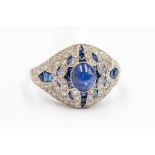 An Art Deco style sapphire and diamond platinum ring, set to the centre with a oval cabochon