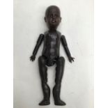 A late 19th century bisque head ethnic doll, open mouth showing four teeth, brown eyes, in need of a