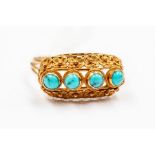 A 1960's gold and turquoise ladies dress ring, set with four cabochons on a gallery setting with