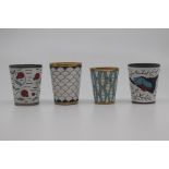 Four Russian enamelled vodka cups, two gilt and two white metal, decorated with stylised and