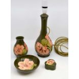 Four Moorcroft pieces, circa late 20th Century, to include table lamp, small vase, pin dish and a