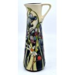 Moorcroft: A Moorcroft tapered ewer with 'Spring Flowers' decoration. Height approx 19cm. Marked