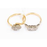 Two three stone diamond set 18ct gold rings, comprising a cross over ring set with illusion set