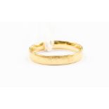 An 18ct gold band, width approx. 4mm, size U, weight approx. 4.4gms