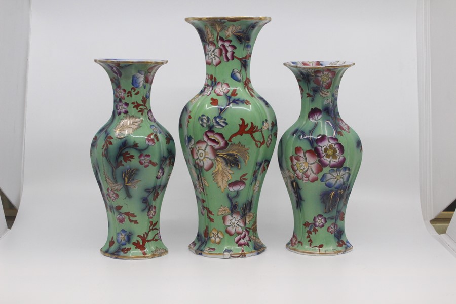 A garniture of English earthenware vases, circa 1850, of lobed ovoid form and decorated with