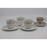A group of Austrian porcelain coffee cups and saucers, including a pair with printed putti on a