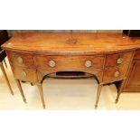 A George III mahogany sideboard, in the manner of George Hepplewhite, raised on square tapered legs,