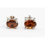 A pair of tourmaline and silver set stud earrings, size approx 5mm, post and scroll fittings