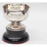 An Edwardian silver trophy, inscribed `Captains Prize 1911', raised on black bakelite detachable
