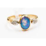 An opal and diamond dress ring, the oval opal approx 9 mm x 6 mm, with blue green play of colour,