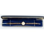 A 9ct gold ladies vintage Shield watch, round champagne dial, baton and number markers, dial approx.