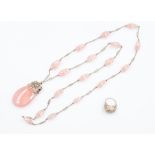 A rose quartz and white metal pendant necklace, comprising a  pearl cut rose quartz pendant with
