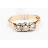 A 9ct three stone diamond ring, claw set, three round brilliant cuts of approx 0.20ct each, size