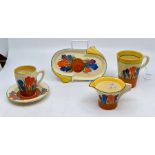 Clarice Cliff: A collection of 'Crocus' pattern items to include cup & saucer, mug, jug and small