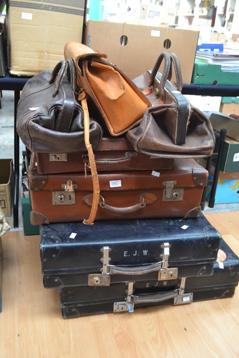 A collection of vintage suitcases and doctors bags