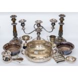 A collection of silver plate including: a pair of Victorian style embossed candlesticks and a