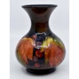 A Moorcroft Flambe 'Leaf and Grape pattern baluster shaped squat vase, early 20th Century, tube