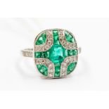 An Art Deco style emerald and diamond platinum ring, set to the centre with an emerald cut