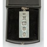 A silver ingot, Birmingham 1977 stamped maker PM, on a silver chain, length approx. 20'', weight