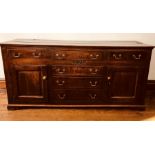 A George III period oak dresser, circa 1770, rectangular form top on a moulded, above three frieze