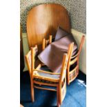 A mid 20th Century teak extending dining room table with four chairs, seats with Schreiber