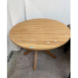 A 20th Century oak circular dining table.