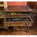 A 19th century and later Oak cased canteen of cutlery, raised on twisted supports united with