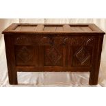 A Charles II oak coffer, circa 1660, the hinged rectangular three panel top above a carved front,