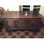 An early 18th Century joined oak chest, plank top opening to reveal candlebox, later hinges but once