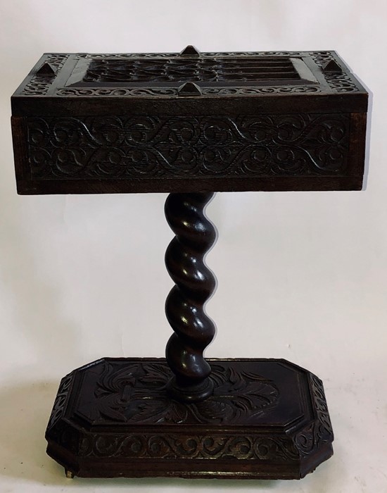 A George III carved oak teapoy, 1815, rectangular shape hinged top with fitted interior, above a