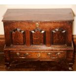 A Mid 18th century Welsh oak coffer bach, hinged lid with moulded edge, three arch raised and