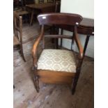 A Victorian mahogany commode chair, bar back