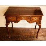 A George III oak low boy, circa 1790, moulded edge top in rectangular form above three frieze