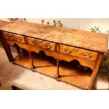 A George III revival oak dresser base utilising older timbers, rectangular top fitted with three