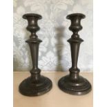 A pair of 19th Century weighted pewter candlesticks, height 24cm (2)