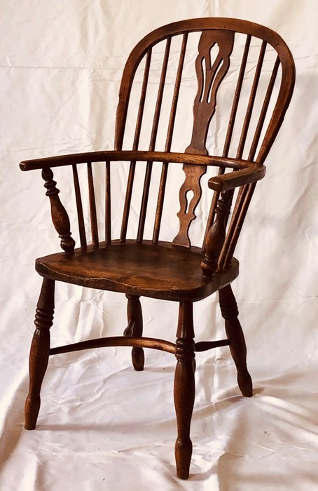 An early 19th Century elm and ash Windsor elbow chair, circa 1810, hoop sparred back centred with