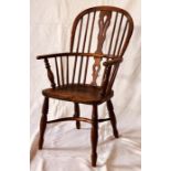 An early 19th Century elm and ash Windsor elbow chair, circa 1810, hoop sparred back centred with