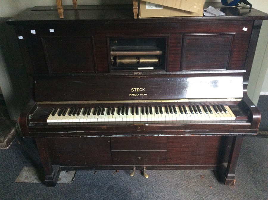 A Steck Pianola upright piano, having seven and a quarter octaves, Ivory keys, with damper and
