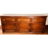 An early George III oak dresser base, circa 1760, rectangular top above moulded edge, fitted with