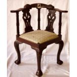 A Chinoiserie hardwood Chippendale style smokers bow corner armchair, scrolled arms, carved floral