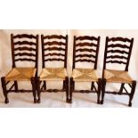 A set of eight early 19th and later century elm rush seated chairs, ladder back with turned